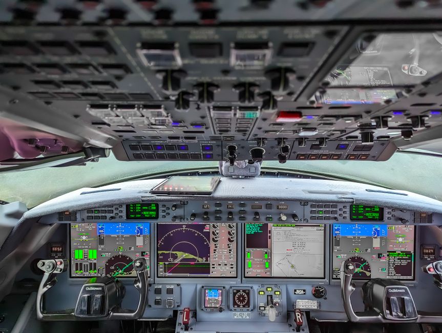 Modern aircraft cockpit showcasing advanced technology and digital control panels.